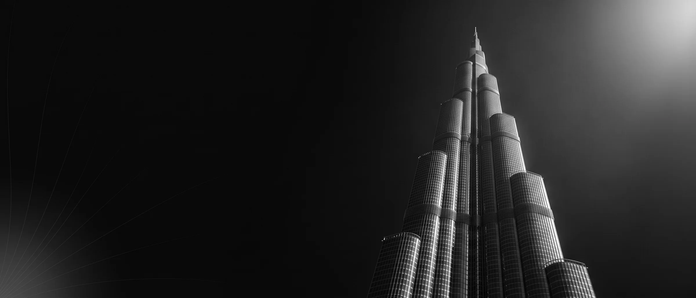 High-rise residential tower in Dubai, shot from a low angle in black and white.