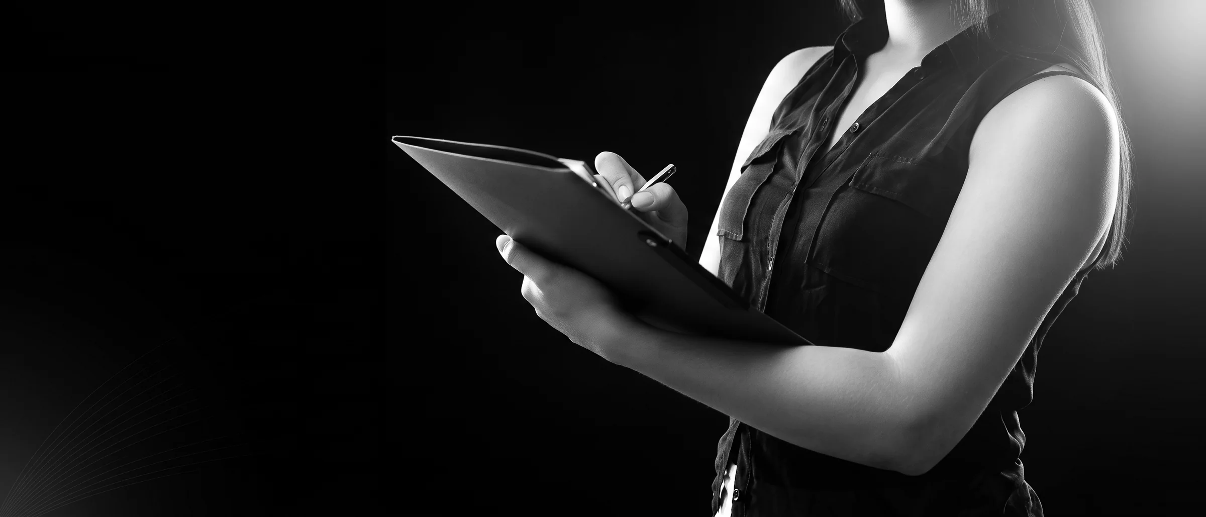 Commercial setter standing with a clipboard, lit by a single hard light with rim separation against black.